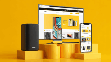 Caixa de som, Monitor e celular expostos em um display