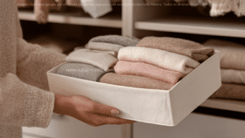 Mulher com uma caixa na mão com roupas dobradas e organizadas