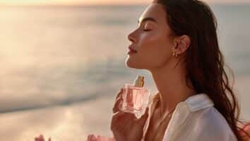 Mulher com frasco de perfume nas mãos